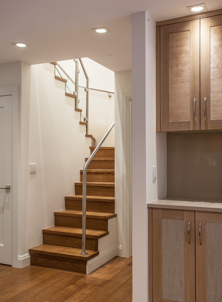 Design ideas for a mid-sized contemporary wood u-shaped staircase in Other with wood risers and metal railing.
