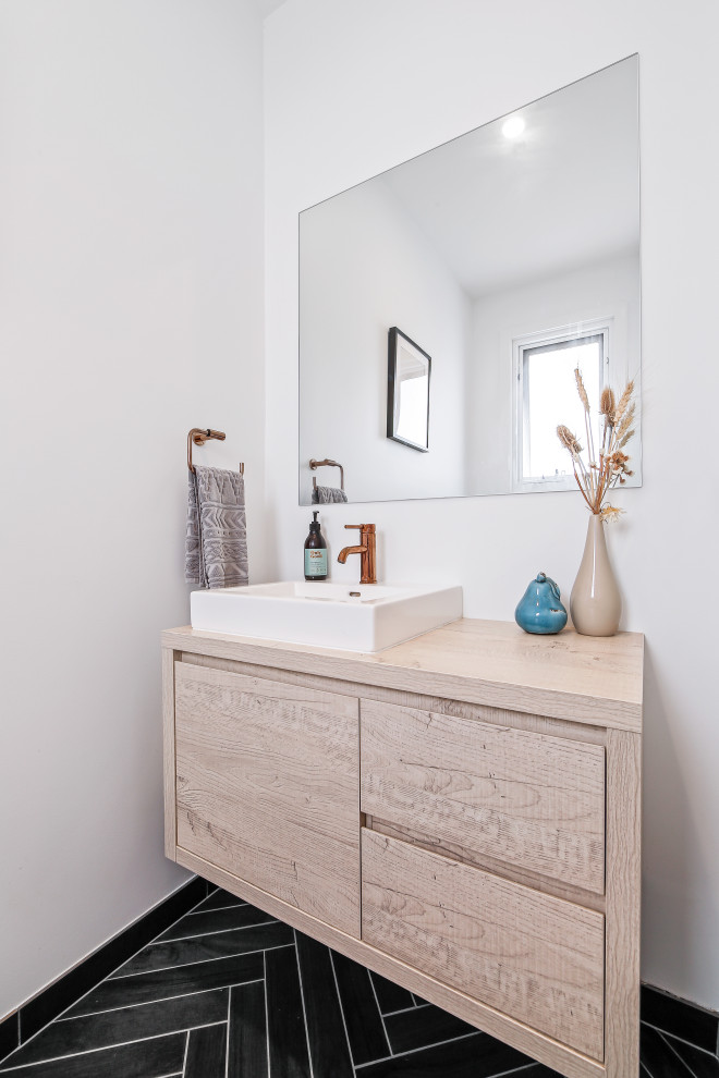 Inspiration for a small beach style 3/4 bathroom in Central Coast with flat-panel cabinets, light wood cabinets, white walls, a vessel sink, wood benchtops, black floor, beige benchtops and a built-in vanity.
