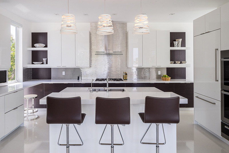 Photo of a large contemporary l-shaped separate kitchen in Miami with a drop-in sink, flat-panel cabinets, white cabinets, concrete benchtops, metallic splashback, metal splashback, stainless steel appliances, with island and porcelain floors.