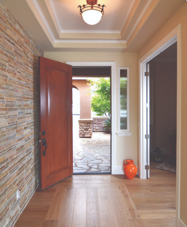 Design ideas for a mid-sized front door in Sacramento with multi-coloured walls, light hardwood floors, a single front door, a medium wood front door, beige floor and coffered.