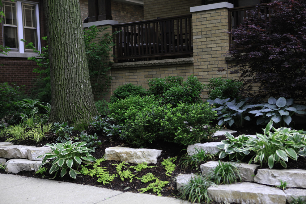 Inspiration for a mid-sized traditional side yard partial sun formal garden in Chicago with concrete pavers.