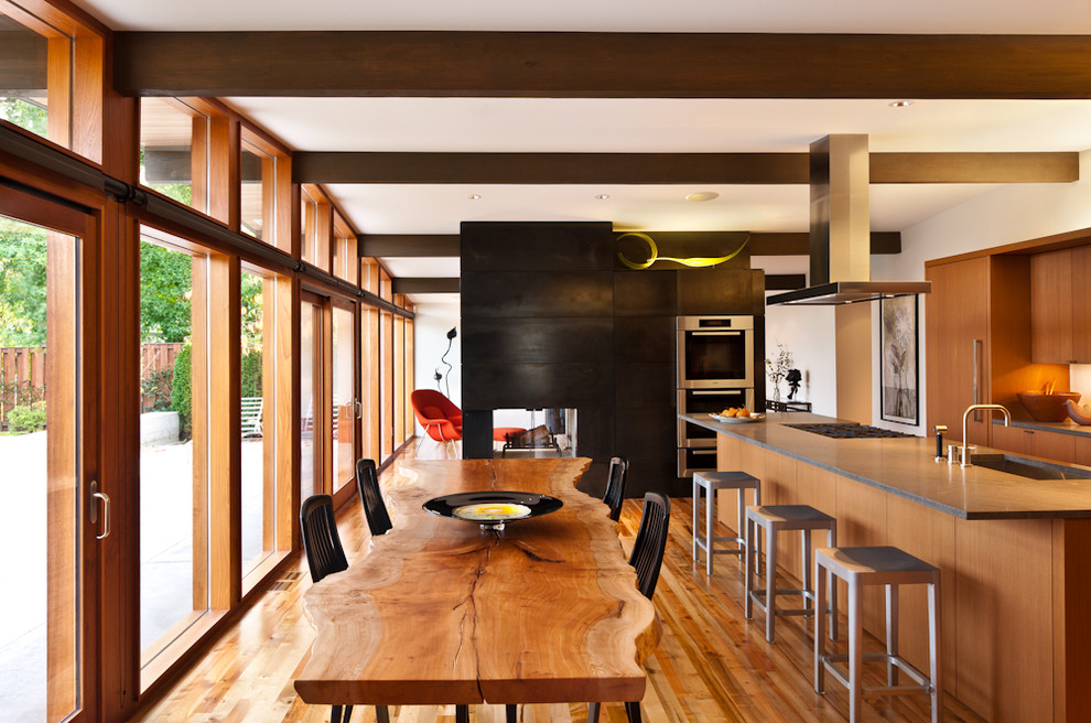 This is an example of a midcentury kitchen in Seattle with concrete benchtops.