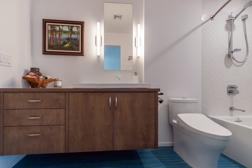 Medium sized retro bathroom in Phoenix with flat-panel cabinets, medium wood cabinets, an alcove bath, a shower/bath combination, a one-piece toilet, white tiles, porcelain tiles, white walls, lino flooring, a built-in sink, wooden worktops, turquoise floors, a shower curtain, a single sink and a floating vanity unit.