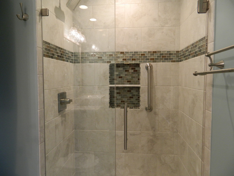 Mid-sized transitional 3/4 gray tile and stone tile porcelain tile alcove shower photo with shaker cabinets, gray cabinets, a one-piece toilet, blue walls, a vessel sink and quartz countertops
