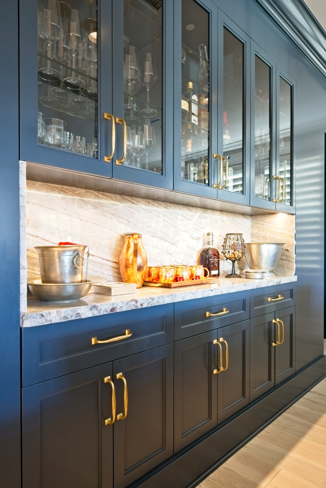 Inspiration for a mid-sized modern single-wall home bar in Orange County with shaker cabinets, blue cabinets, quartzite benchtops, multi-coloured splashback, light hardwood floors, beige floor and multi-coloured benchtop.