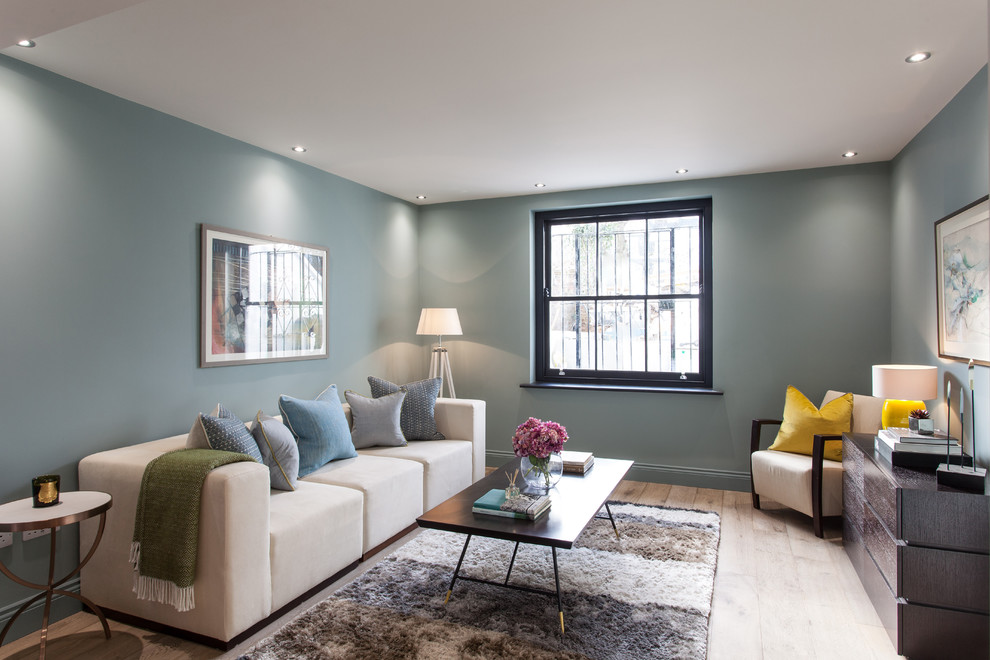 This is an example of a mid-sized contemporary family room in London with blue walls.