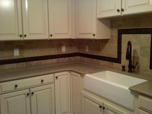 Inspiration for a transitional kitchen remodel with an undermount sink, raised-panel cabinets, white cabinets, granite countertops, beige backsplash and travertine backsplash