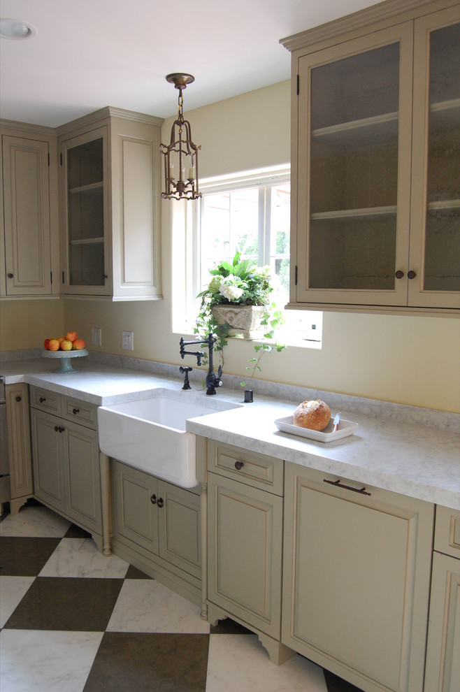 Inspiration for a small country kitchen in Los Angeles with a farmhouse sink, grey cabinets, onyx benchtops, panelled appliances and marble floors.
