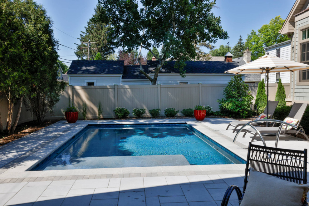 Small elegant backyard stone and rectangular pool house photo in Chicago