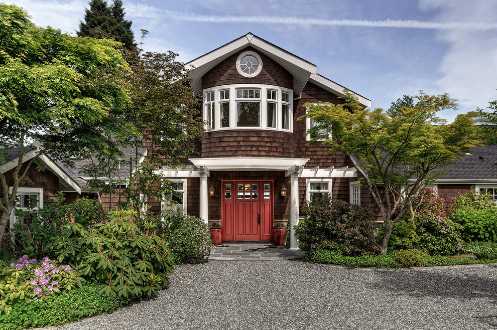 Large beach style two-storey brown exterior in Seattle with wood siding and a gable roof.