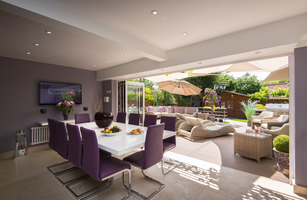 Mid-sized contemporary dining room in Buckinghamshire with purple walls, beige floor and no fireplace.
