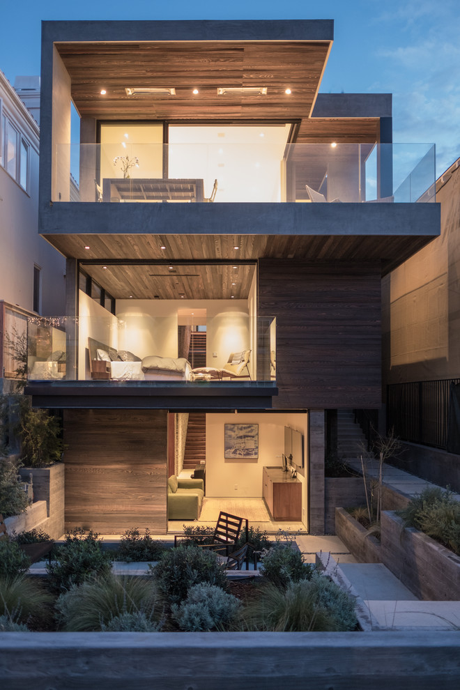 Photo of a contemporary three-storey brown house exterior in Los Angeles with wood siding and a flat roof.
