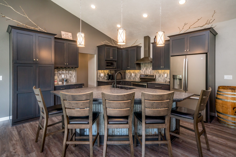 Inspiration for a small rustic l-shaped medium tone wood floor open concept kitchen remodel with dark wood cabinets, multicolored backsplash, stainless steel appliances and an island