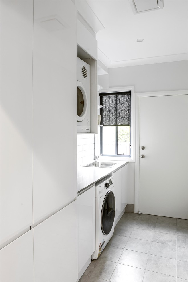 This is an example of a beach style laundry room in Sydney.