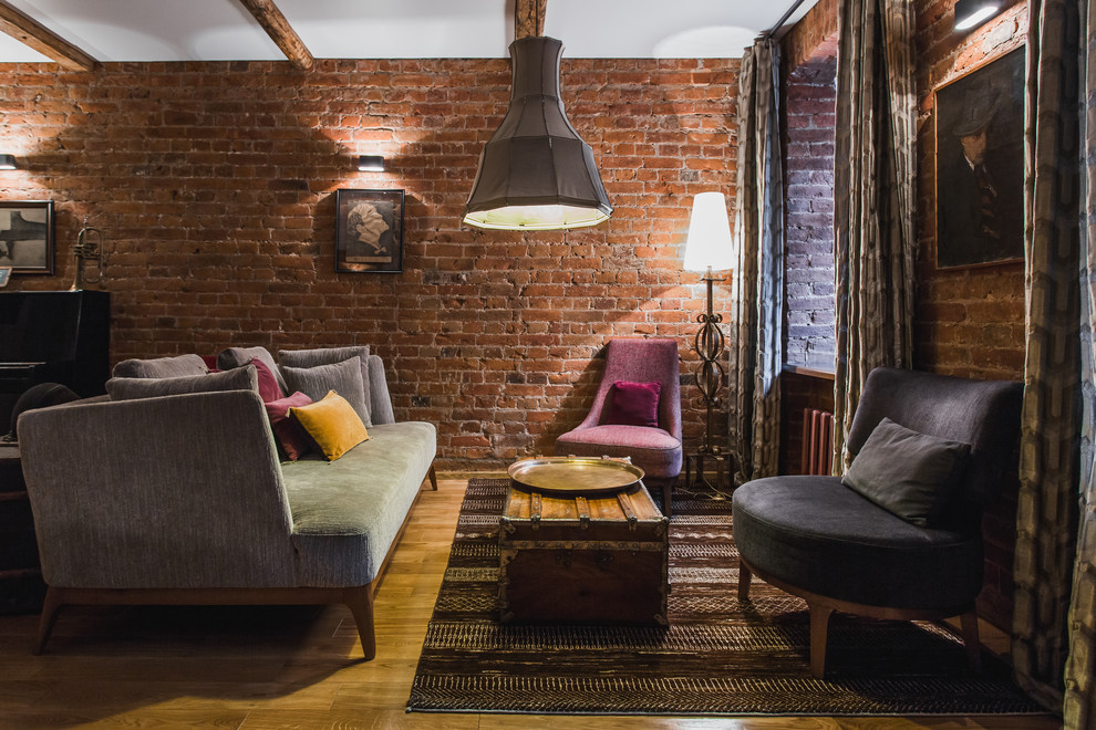 This is an example of an industrial formal open concept living room in Moscow with medium hardwood floors, no tv and brown walls.