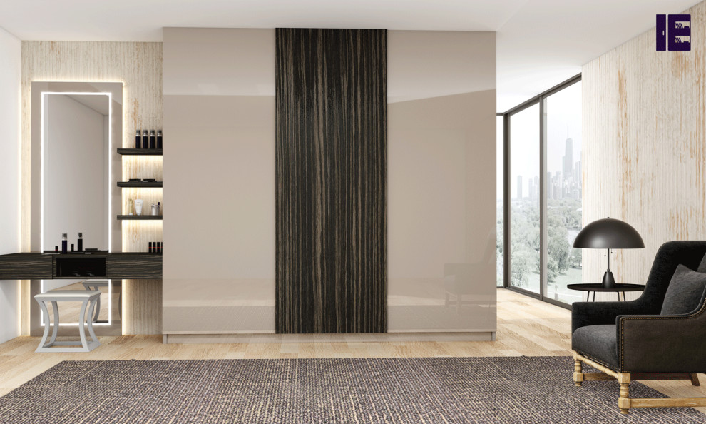 This is an example of a large contemporary built-in wardrobe in London with flat-panel cabinets and beige cabinets.