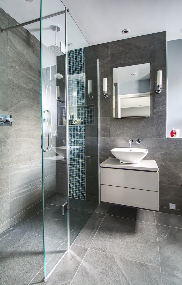 Design ideas for a small contemporary master bathroom in Hampshire with flat-panel cabinets, grey cabinets, an open shower, a wall-mount toilet, gray tile, ceramic tile, blue walls, ceramic floors, a console sink, laminate benchtops, grey floor and a shower curtain.