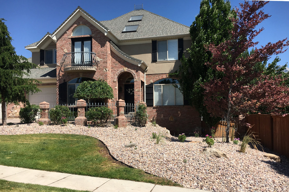 This is an example of a mid-sized contemporary front yard full sun xeriscape in Salt Lake City with concrete pavers.