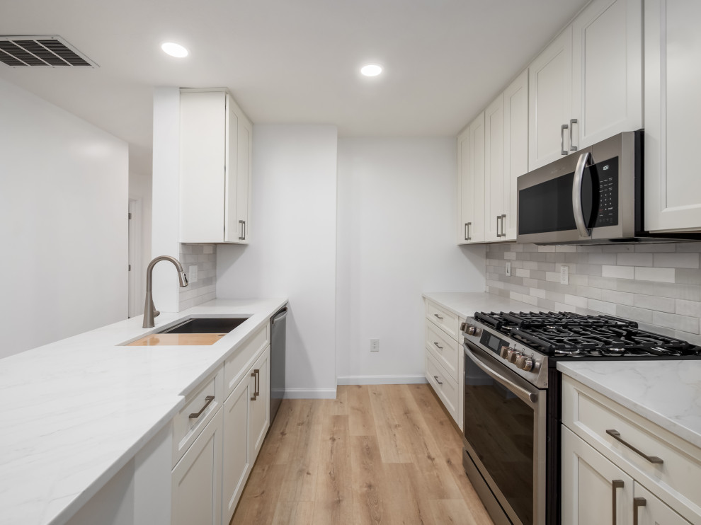 Small transitional galley eat-in kitchen photo in Columbus with shaker cabinets, white cabinets, quartz countertops and white countertops