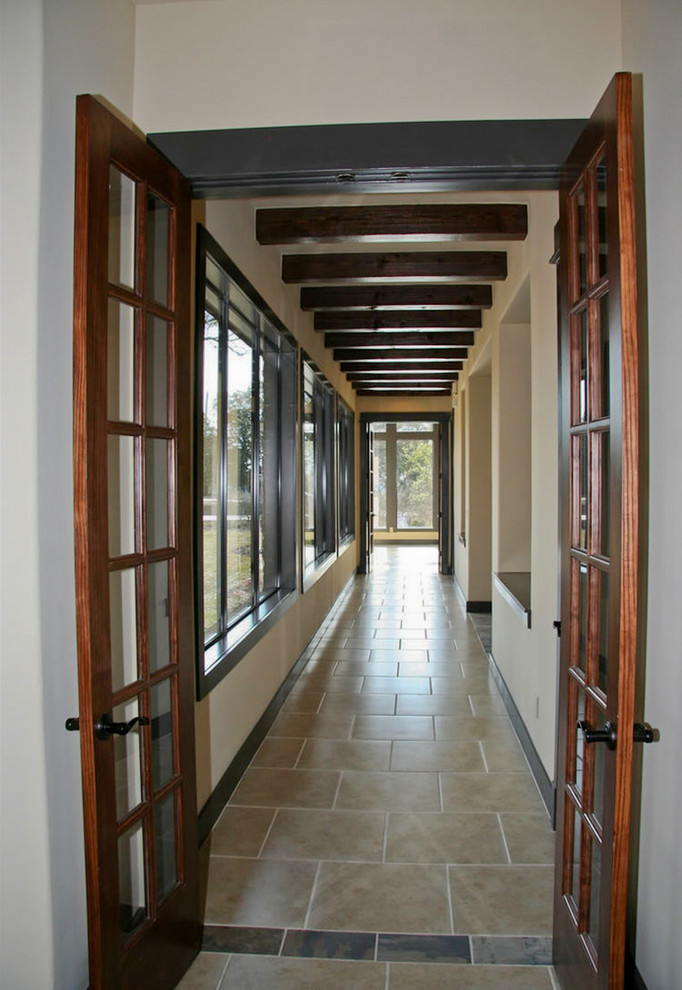 Photo of a large contemporary hallway in Austin with ceramic floors.