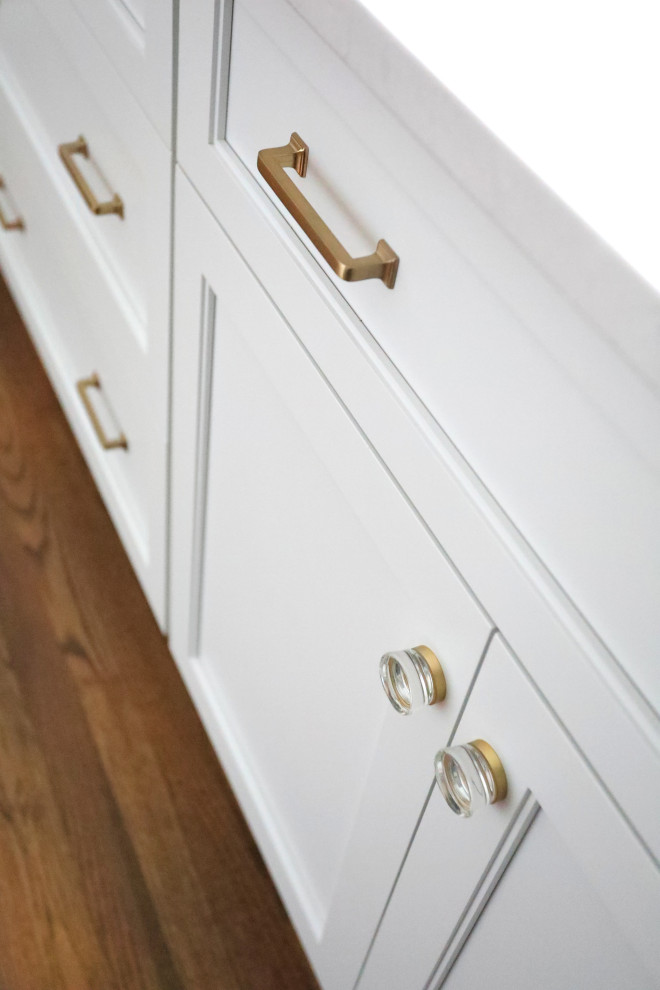 Example of a transitional medium tone wood floor and brown floor eat-in kitchen design in Chicago with beaded inset cabinets, quartz countertops, white countertops and white cabinets