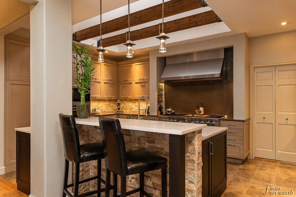 Inspiration for a mid-sized transitional u-shaped enclosed kitchen remodel in Dallas with an undermount sink, flat-panel cabinets, light wood cabinets, stone tile backsplash, stainless steel appliances and an island