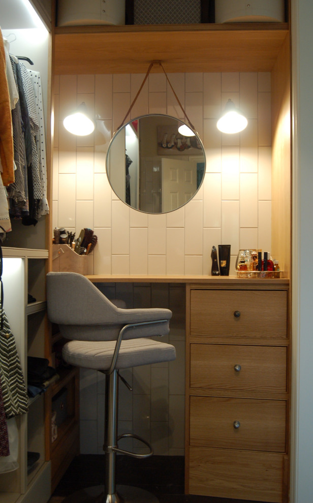 Photo of a small contemporary dressing room for women in Gloucestershire with open cabinets, grey cabinets, dark hardwood flooring and brown floors.