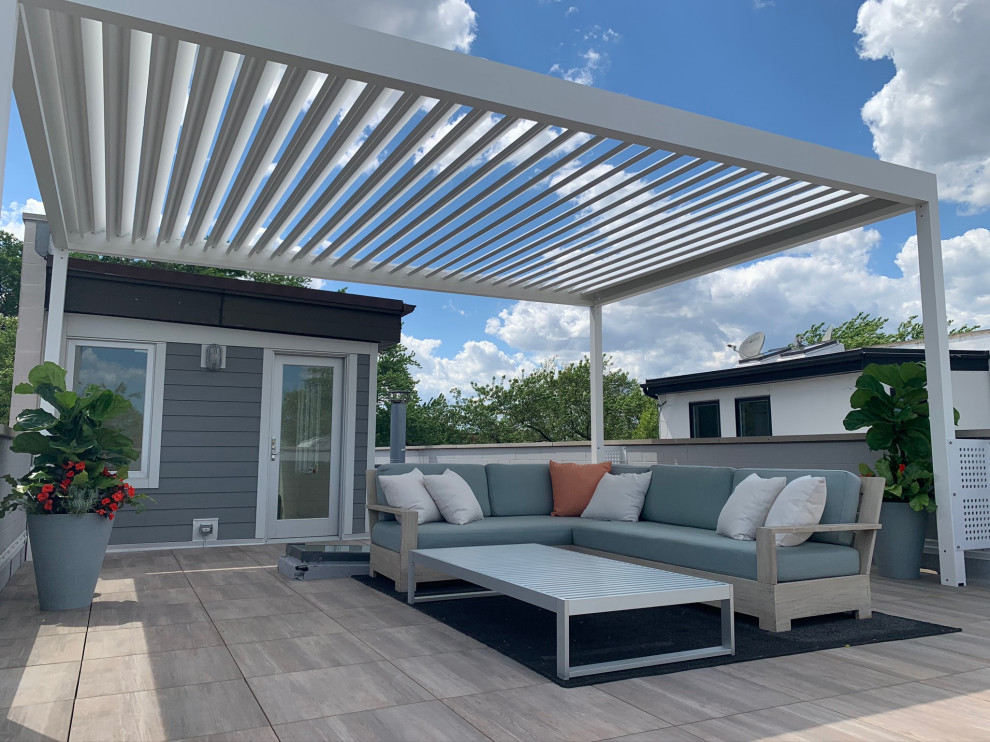 This is an example of a small modern rooftop and rooftop deck in Chicago with a pergola.
