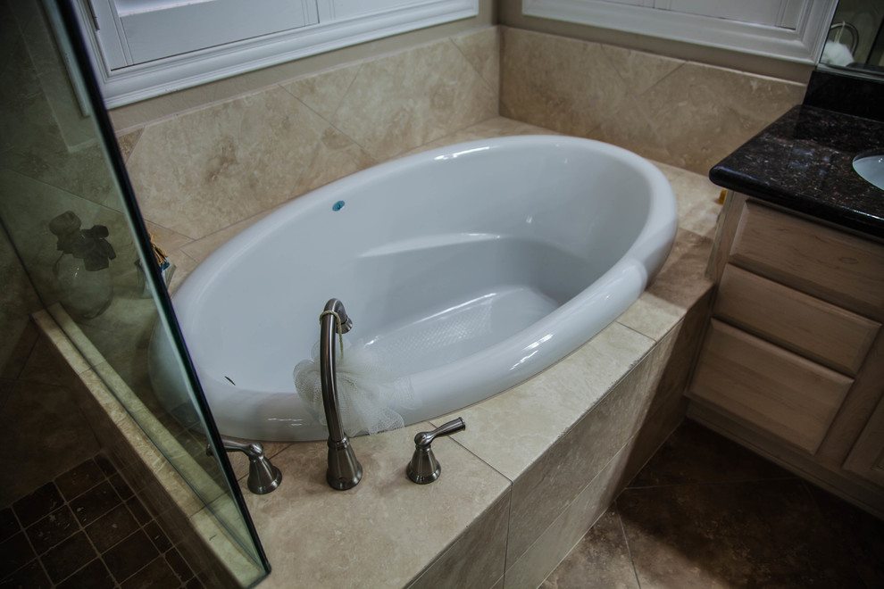 Inspiration for a large transitional master ceramic tile drop-in bathtub remodel in Phoenix with raised-panel cabinets, light wood cabinets, beige walls, an undermount sink and granite countertops