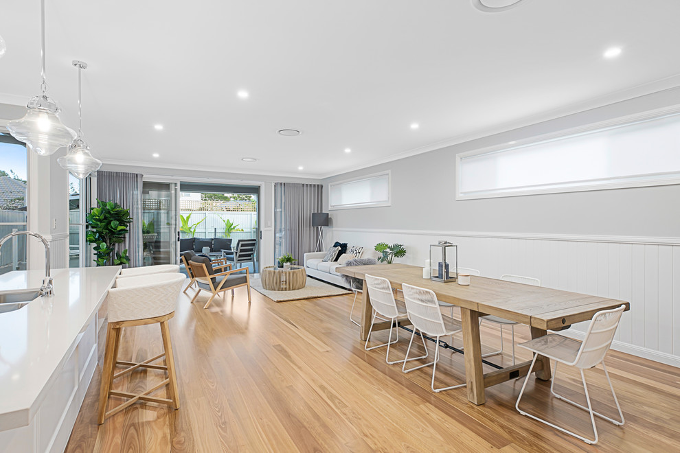 Inspiration for a large contemporary open plan dining in Brisbane with grey walls, medium hardwood floors and no fireplace.