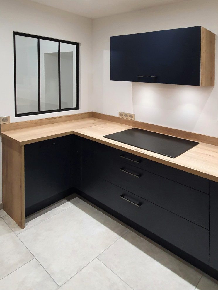 Photo of a large contemporary single-wall open plan kitchen in Other with an undermount sink, flat-panel cabinets, stainless steel cabinets, wood benchtops, brown splashback, timber splashback, panelled appliances, concrete floors, no island, grey floor and brown benchtop.