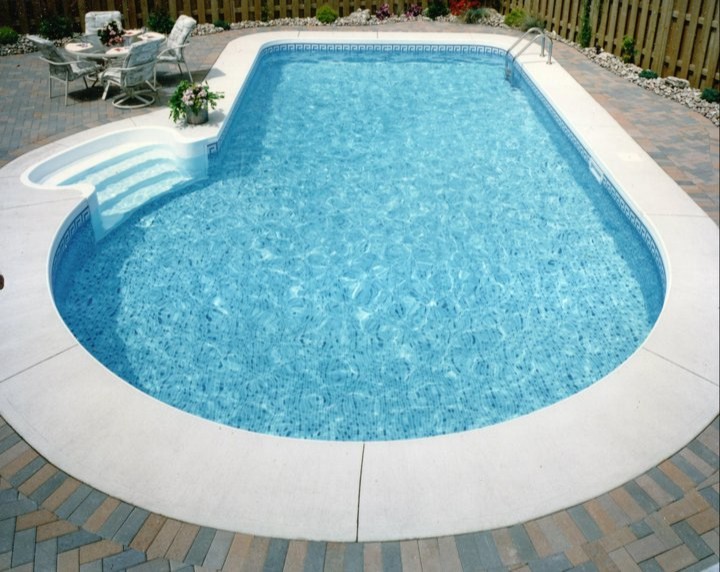 Inspiration for a large backyard stone pool remodel in Toronto