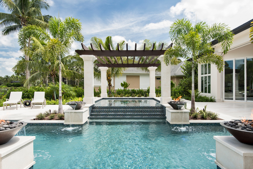 Photo of an expansive contemporary backyard custom-shaped pool in Miami with a hot tub.