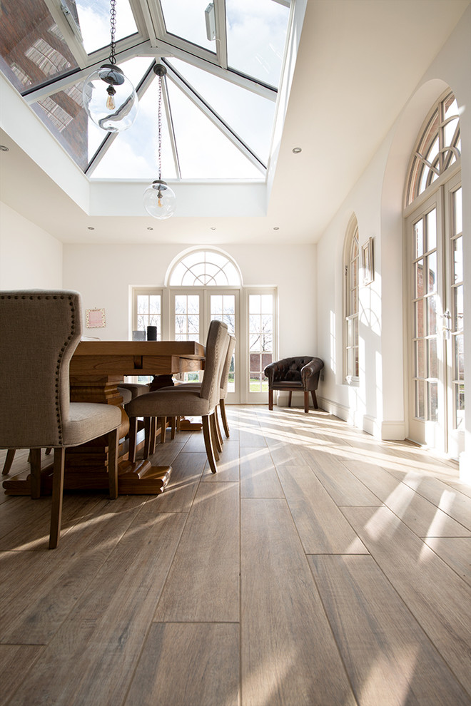 Photo of a mid-sized country dining room in Other with porcelain floors.