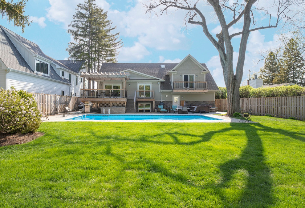 Pool - large craftsman backyard stone and rectangular pool idea in Chicago