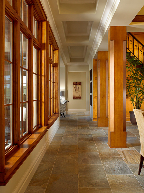 Photo of a large transitional hallway in Tampa with beige walls and slate floors.