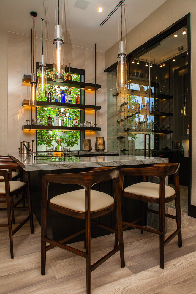 Inspiration for a mid-sized contemporary l-shaped medium tone wood floor and brown floor seated home bar remodel in Miami with flat-panel cabinets, dark wood cabinets, granite countertops and multicolored countertops