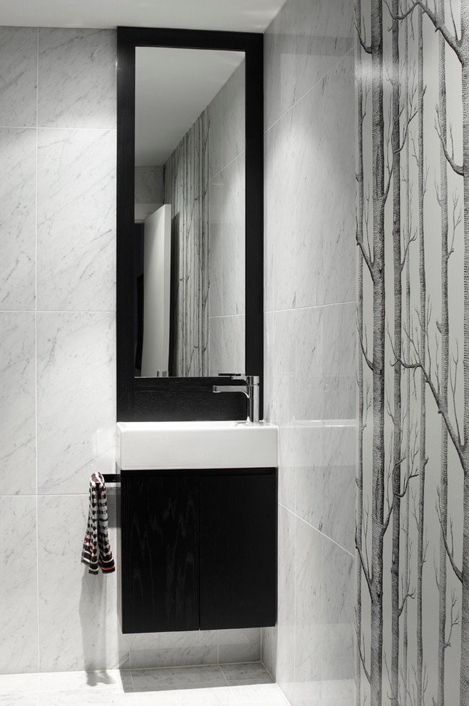 Photo of a small contemporary bathroom in Sydney with an integrated sink, furniture-like cabinets, dark wood cabinets, stone tile and marble floors.