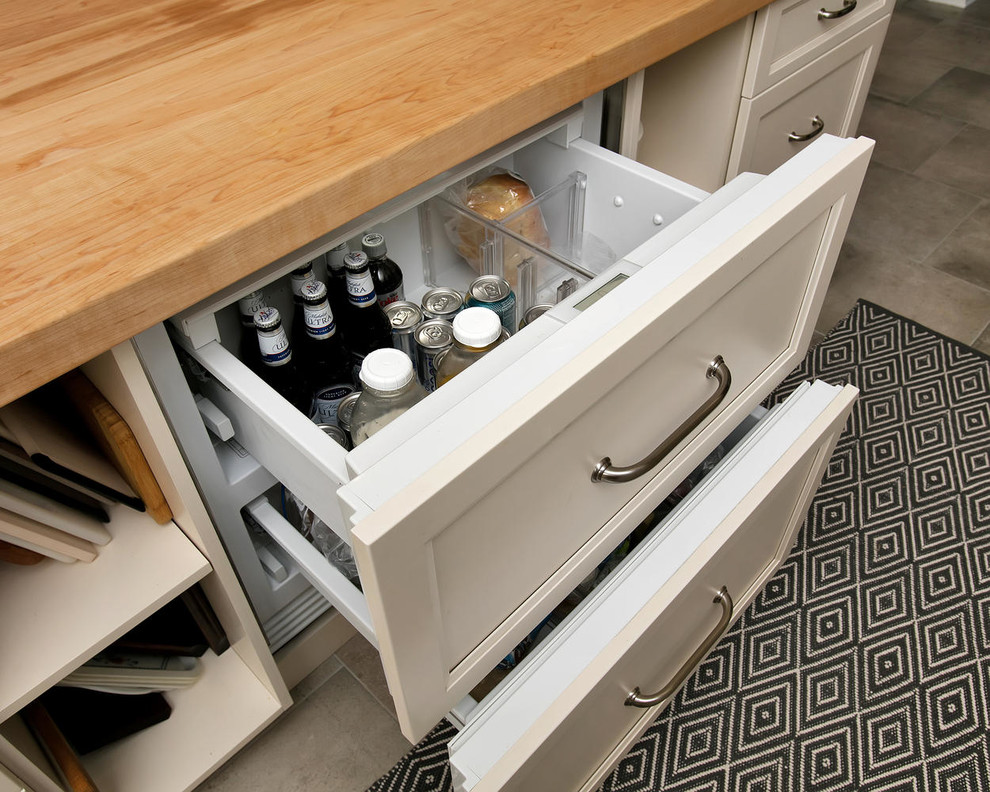 Mid-sized transitional u-shaped porcelain tile eat-in kitchen photo in New York with an undermount sink, recessed-panel cabinets, white cabinets, wood countertops, gray backsplash, subway tile backsplash, stainless steel appliances and an island