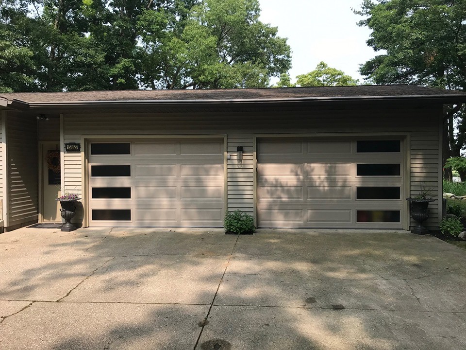 Photo of a mid-sized midcentury attached two-car garage in St Louis.