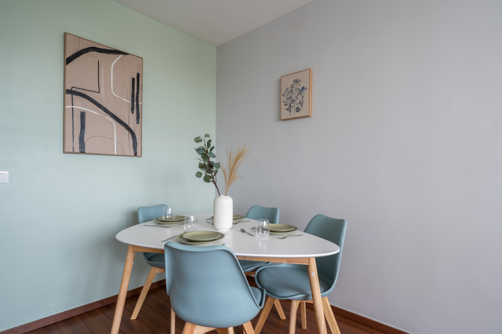 Cette image montre une salle à manger ouverte sur le salon design de taille moyenne avec un mur vert, parquet foncé, aucune cheminée et un sol marron.
