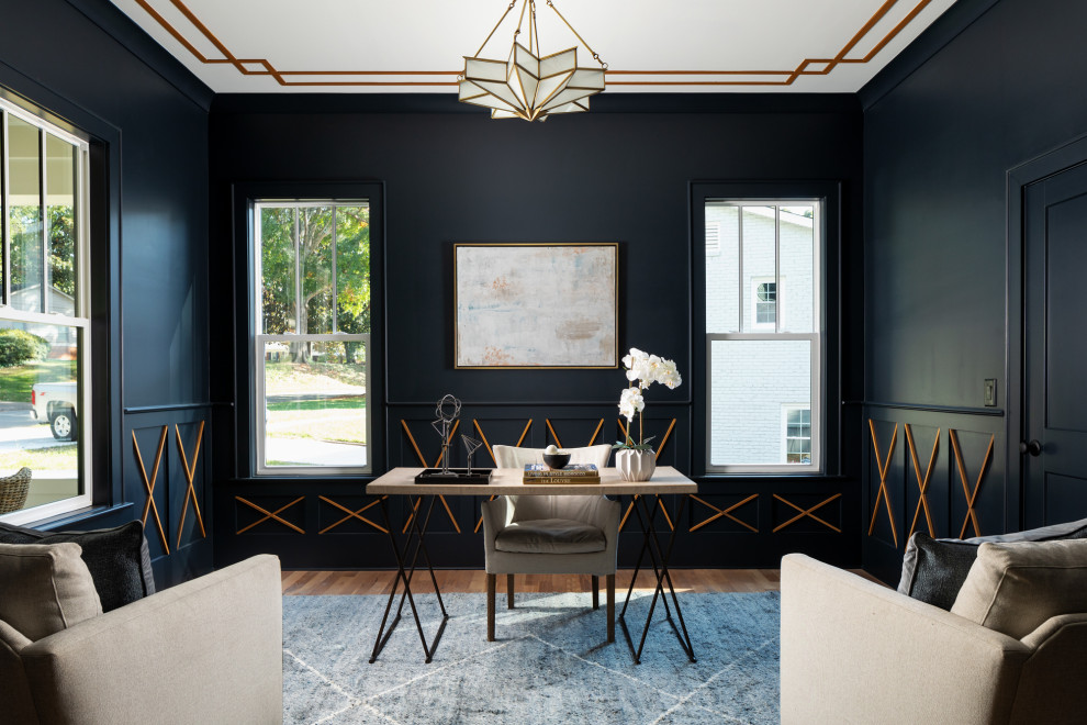 Diseño de despacho tradicional renovado con paredes negras, suelo de madera en tonos medios, escritorio independiente, suelo marrón y panelado
