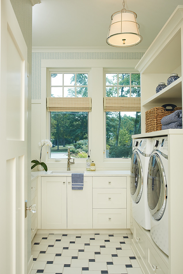 Design ideas for a large traditional u-shaped dedicated laundry room in Grand Rapids with an undermount sink, recessed-panel cabinets, white cabinets, quartz benchtops, a side-by-side washer and dryer and multi-coloured floor.