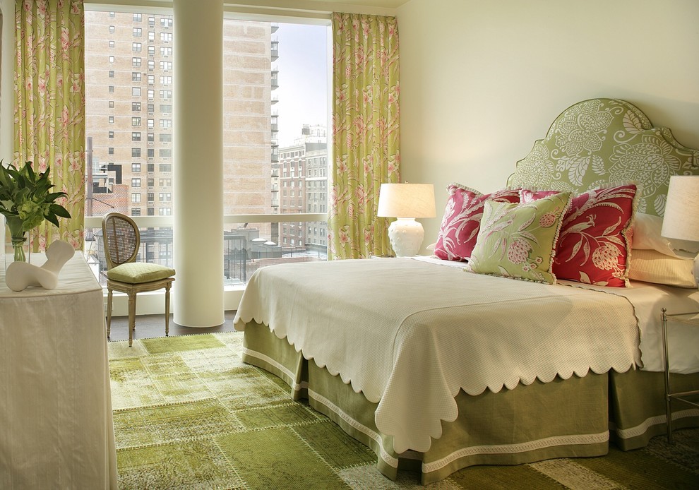 This is an example of a modern master bedroom in New York with beige walls, carpet and green floor.