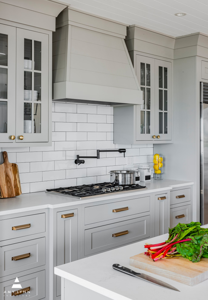 Eat-in kitchen - large farmhouse u-shaped light wood floor, brown floor and shiplap ceiling eat-in kitchen idea in Boston with a farmhouse sink, shaker cabinets, gray cabinets, quartz countertops, white backsplash, ceramic backsplash, stainless steel appliances, an island and white countertops