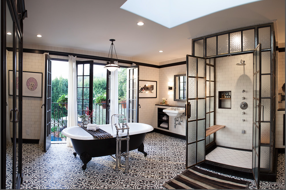 Traditional master bathroom in Los Angeles with a wall-mount sink, a one-piece toilet, white walls and concrete floors.