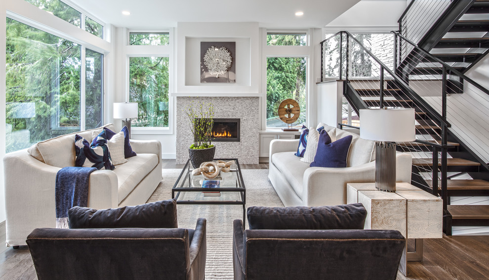 This is an example of a large transitional formal open concept living room in Seattle with white walls, medium hardwood floors, a standard fireplace, a stone fireplace surround, a wall-mounted tv and brown floor.