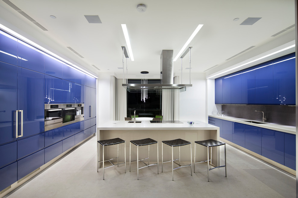 Contemporary galley kitchen in Los Angeles with an undermount sink, flat-panel cabinets, blue cabinets, black splashback, mosaic tile splashback, stainless steel appliances and with island.