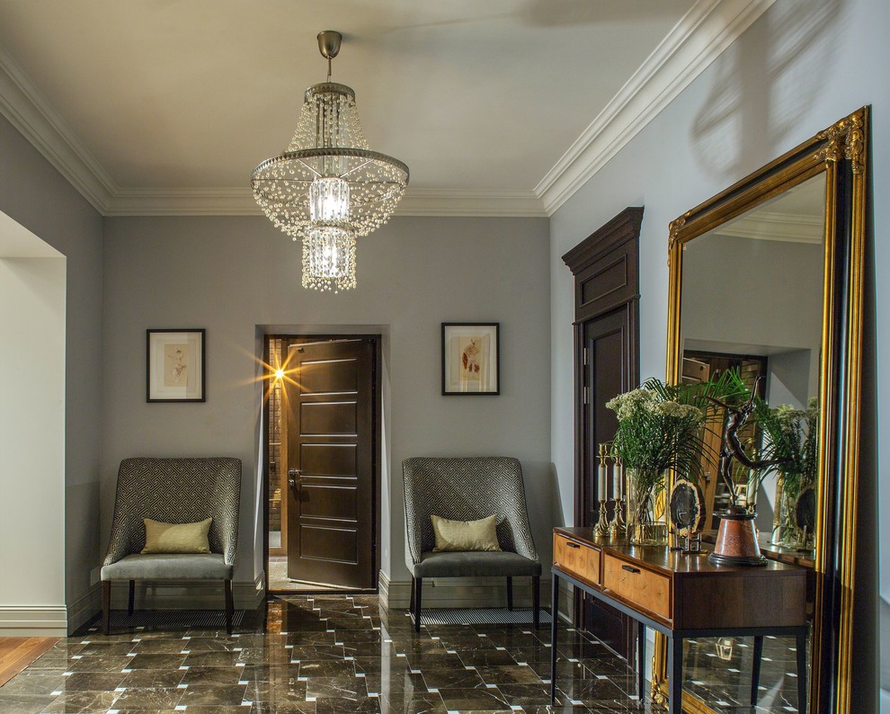 This is an example of a large contemporary foyer in Moscow with grey walls, marble floors, a single front door, a brown front door and brown floor.