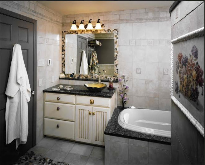 Mid-sized transitional master beige tile, black tile, brown tile and pebble tile ceramic tile and gray floor drop-in bathtub photo with recessed-panel cabinets, beige cabinets, a one-piece toilet, a vessel sink and granite countertops